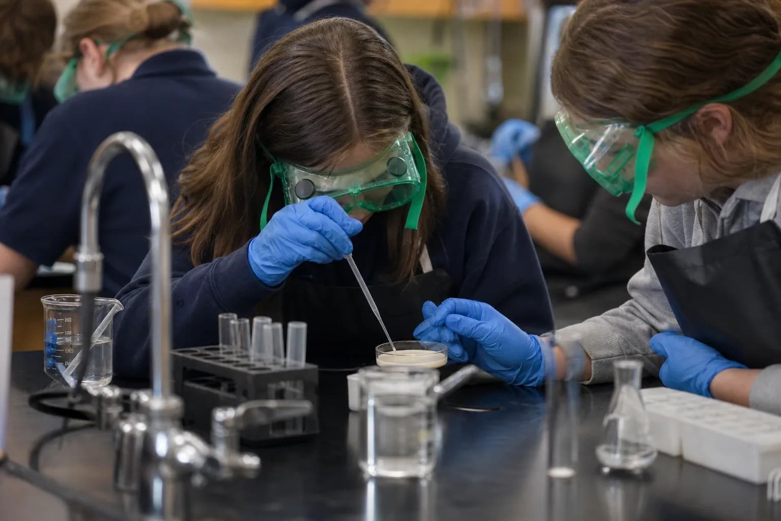 Students conducting a supervised science experiment